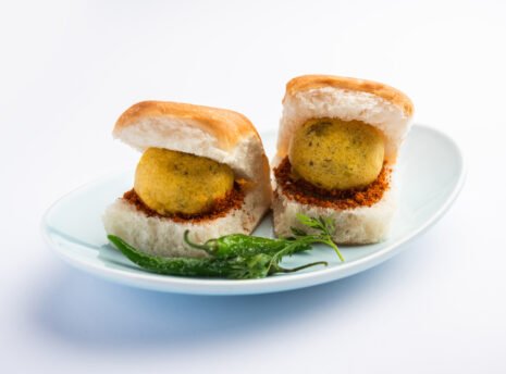 vada-pav-wada-pao-is-indian-desi-burger-is-roadside-fast-food-dish-from-maharashtra-selective-focus(1) vada-pav-wada-pao-is-indian-desi-burger-is-roadside-fast-food-dish-from-maharashtra-selective-focus(1)