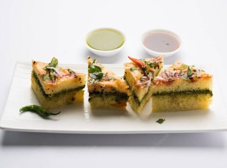 yellow-sandwich-dhokla-is-indian-savoury-snack-made-chick-pea-flour-rice-flour-originated-gujarat-served-with-green-tamarind-chutney-selective-focus_466689-58608 yellow-sandwich-dhokla-is-indian-savoury-snack-made-chick-pea-flour-rice-flour-originated-gujarat-served-with-green-tamarind-chutney-selective-focus_466689-58608